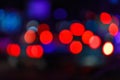 Multicolored sparkles of street lamps and shop windows with bokeh effect. Defocused background
