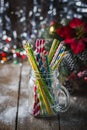 Multicolored spiral straw cocktails in a glass jar Mason on a festive New Year`s background. Sweet table. A table with a drink. Royalty Free Stock Photo