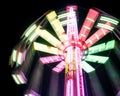 Multicolored Star Flyer tall Carousel rotating on long chains in an amusement park. Entertainment and leisure activities concept
