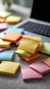 Multicolored sticky notes surrounding laptop on desk, highlighting workspace organization and productive planning for Royalty Free Stock Photo