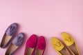 Multicolored suede moccasins shoes over pink background