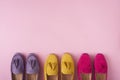 Multicolored suede moccasins shoes over pink background
