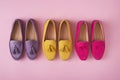 Multicolored suede moccasins shoes over pink background