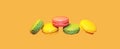 Multicolored sweet macaroons on yellow background