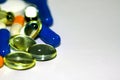 Multicolored tablets and capsules piled with a slide