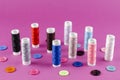 Multicolored thread spools and buttons on purple background Royalty Free Stock Photo