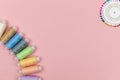 Multicolored threads of the coil, needle pins on a pink background. Sewing supplies, patterns and accessories for Royalty Free Stock Photo