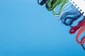 Multicolored threads for embroidery floss on a blue Royalty Free Stock Photo