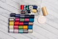 multicolored threads and other sewing accessories on the table needles pins fastener