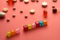 Multicolored title NEW CHANCE from transparent cubes on the table with tablets on coral background.