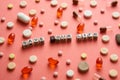 Multicolored title SAVE YOUR LIFE from white and black cubes on the table with tablets on coral background.