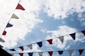 Multicolored Triangular Flags Hanging in the Sky at an Outdoor. Garland of bright colored developing in the wind against the backg Royalty Free Stock Photo