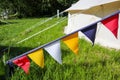 multicolored triangular flags on a tent incamp