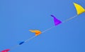 Multicolored triangular small flags to celebration party against blue sky.Street holiday concept for design.