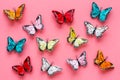 Multicolored tropical butterflies on pink background top-down pattern