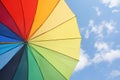 Multicolored umbrella against the sunny sky