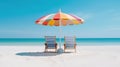 Multicolored umbrella, two beach beds and white sand on sea shore in summer Royalty Free Stock Photo