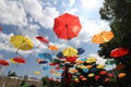 Colorful umbrellas flying in the summer blue sky.