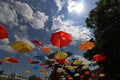 Colorful umbrellas flying in the summer blue sky.