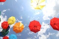 Colorful umbrellas flying in the summer blue sky.