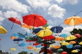 Colorful umbrellas flying in the summer blue sky.