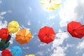 Colorful umbrellas flying in the summer blue sky.