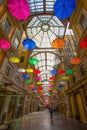 Multicolored umbrellas in the sky above Galleria Mazzini in the center of Genoa, Italy.