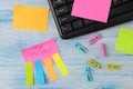 Multicolored various notes or sticky post-it on the background of a wooden office table and office supplies. workplace. Royalty Free Stock Photo