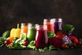 Multicolored vegan vegetable juices and smoothies from tomato, carrot, pepper, cabbage, spinach, beetroot in glass bottles on Royalty Free Stock Photo