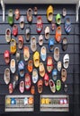 Multicolored vintage Dutch Klomp shoes on black wood panel background