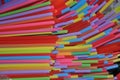 Multicolored vivid plastic drinking straws in a decorative background frame full of straws for a celebration, holiday or festival