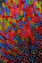 Multicolored vivid plastic drinking straws in a decorative background frame full of straws for a celebration, holiday or festival