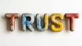 Multicolored, Weathered Painted Letters Spelling Concept Trust Typography On White Background Royalty Free Stock Photo