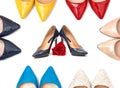 Multicolored women`s shoes with high heels standing in a row on a white surface with a red rose