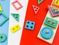 Multicolored wooden blocks on red blue background. Trendy puzzle toys. Geometric shapes: square, circle, triangle, rectangle. Royalty Free Stock Photo