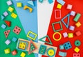 Multicolored wooden blocks on red blue green background. Trendy puzzle toys. Geometric shapes.  Educational toys for kindergarten, Royalty Free Stock Photo