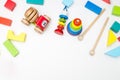 Multicolored wooden children`s toys on a white background. Mocku