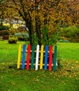 Multicolored wooden fence part in a garden Royalty Free Stock Photo