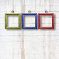Multicolored wooden frames for pictures on stone wall Royalty Free Stock Photo