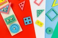 Multicolored wooden toys, blocks on green blue background. Trendy puzzle toys. Geometric shapes: square, circle, triangle, Royalty Free Stock Photo