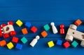 Multicolored wooden toys cubes, pyramid and cars on classic blue background. Set colorful toys for games in kindergarten, Royalty Free Stock Photo