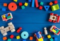 Multicolored wooden toys cubes, pyramid and cars on classic blue background. Set colorful toys for games in kindergarten, Royalty Free Stock Photo