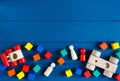 Multicolored wooden toys cubes, pyramid and cars on classic blue background. Set colorful toys for games in kindergarten, Royalty Free Stock Photo