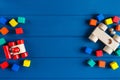 Multicolored wooden toys cubes, pyramid and cars on classic blue background. Set colorful toys for games in kindergarten, Royalty Free Stock Photo