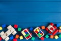 Multicolored wooden toys cubes, pyramid and cars on classic blue background. Set colorful toys for games in kindergarten, Royalty Free Stock Photo