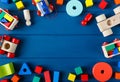 Multicolored wooden toys cubes, pyramid and cars on classic blue background. Set colorful toys for games in kindergarten, Royalty Free Stock Photo