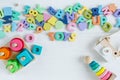 Multicolored wooden toys cubes, pyramid, letters, numbers on white wooden background. Set colorful toys for games in kindergarten Royalty Free Stock Photo