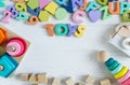 Multicolored wooden toys cubes, pyramid, letters, numbers on white wooden background. Set colorful toys for games in kindergarten Royalty Free Stock Photo