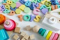 Multicolored wooden toys cubes, pyramid, letters, numbers on white wooden background. Set colorful toys for games in kindergarten, Royalty Free Stock Photo