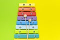 Multicolored wooden xylophone, shock sticks on yellow and green background flat lay top view copy space. Wooden children`s musica Royalty Free Stock Photo
